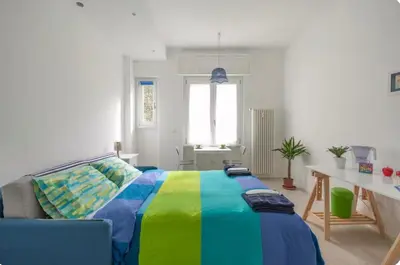 a bedroom with a bed with a colorful blanket at luminoso spazio nel barocchetto romano in Rome