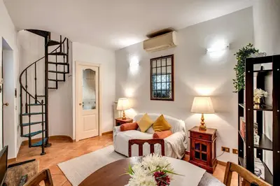 a living room with a couch and a table at Charlotte Luxury Home Coronari in Rome