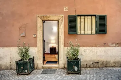 an open door to a building with two plants at Charlotte Luxury Home Coronari in Rome