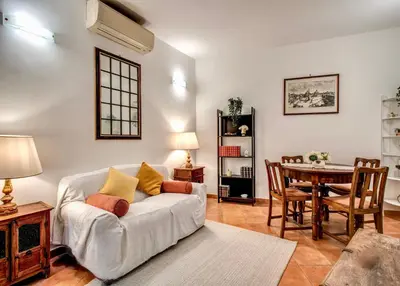 a living room with a white couch and a table at Charlotte Luxury Home Coronari in Rome