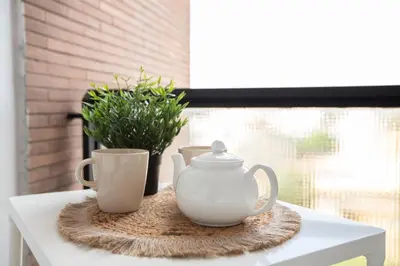 two cups and a tea pot on a table at San Paolo Suites Metro Station in Rome