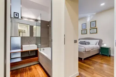 a bedroom with a bed and a bathroom with a tub at BDC - Purple Apt at San Giovanni in Rome
