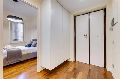 a bedroom with a bed and a large sliding door at BDC - Purple Apt at San Giovanni in Rome