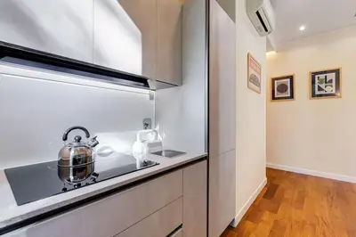 a kitchen counter with a tea kettle on a stove at BDC - Purple Apt at San Giovanni in Rome