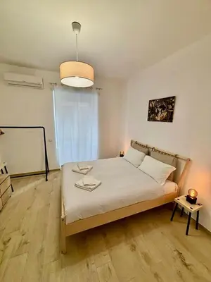 a bedroom with a bed in a room with a light at Pamphili Home - Un angolo di pace vicino Trastevere in Rome