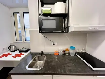 a small kitchen with a sink and a microwave at Pamphili Home - Un angolo di pace vicino Trastevere in Rome
