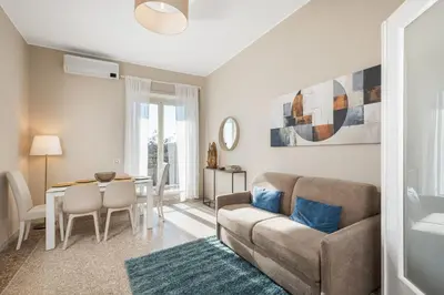 a living room with a couch and a table at Conca d'oro house in Rome