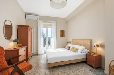 a bedroom with a bed and a dresser and a mirror at Conca d'oro house in Rome