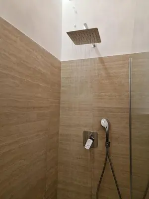 a shower with a shower head in a bathroom at VATICAN GUEST HOUSE ROOMS in Rome in Rome