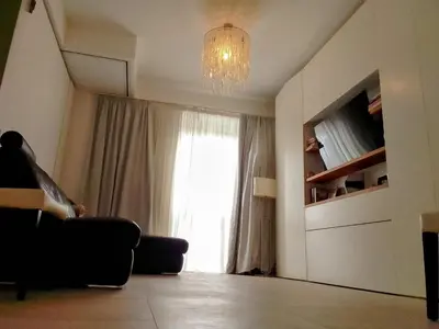 a living room with a large window and a chandelier at VATICAN GUEST HOUSE ROOMS in Rome in Rome