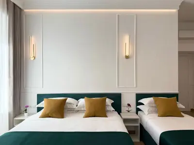 two beds in a room with white and green at Nova Luxe in Rome