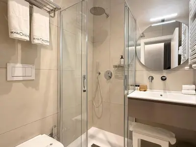 a bathroom with a shower and a toilet and a sink at Nova Luxe in Rome