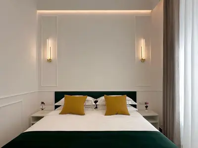 a bedroom with a large bed with yellow pillows at Nova Luxe in Rome