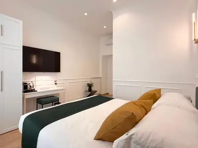 a bedroom with a large bed with a tv on the wall at Nova Luxe in Rome