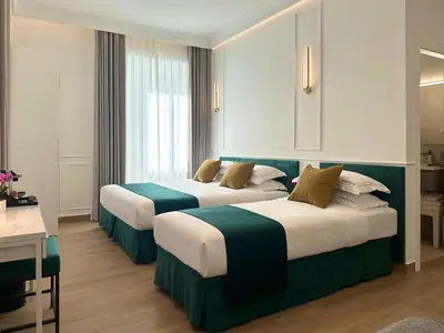 a hotel room with two beds in a room at Nova Luxe in Rome