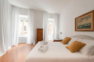 a bedroom with a white bed with towels on it at Colosseum Number sixteen apartment in Rome