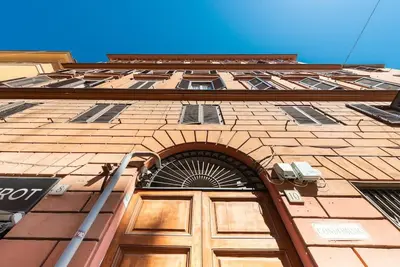 a building with a wooden door in front of it at Colosseum Number sixteen apartment in Rome