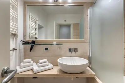 a bathroom with a sink and a mirror at Ciancaleoni Gruppo M&L Apartments in Rome