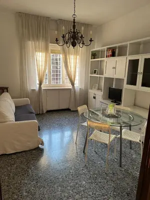 a living room with a glass table and a couch at Silvia's Home in Rome