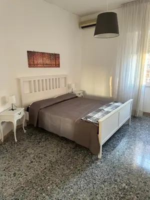 a bedroom with a large bed and a table at Silvia's Home in Rome