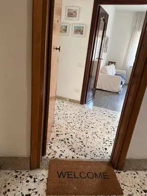 a doorway into a room with a welcome mat in front of a mirror at Silvia's Home in Rome
