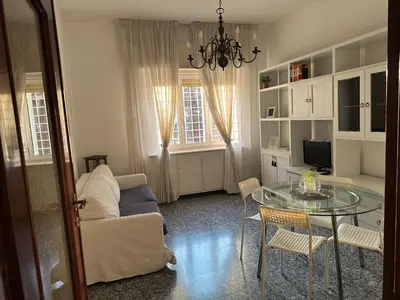 a living room with a couch and a glass table at Silvia's Home in Rome