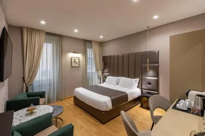 a hotel room with a bed and a couch at Ara di Marte Home in Rome