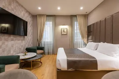 a bedroom with a large bed and a desk at Ara di Marte Home in Rome