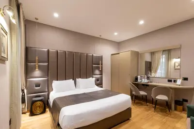 a hotel room with a bed and a desk at Ara di Marte Home in Rome