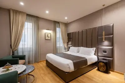a hotel room with a bed and a table and chairs at Ara di Marte Home in Rome