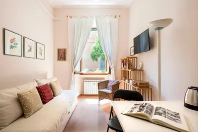 a living room with a couch and a table at Vatican Museums Cozy Apartment in Rome