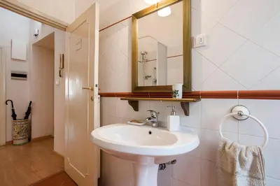 a bathroom with a sink and a mirror at Vatican Museums Cozy Apartment in Rome
