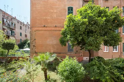 an old brick building with a tree in front of it at Vatican Museums Cozy Apartment in Rome