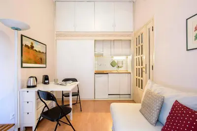 a small apartment with a desk and a bed and a kitchen at Vatican Museums Cozy Apartment in Rome