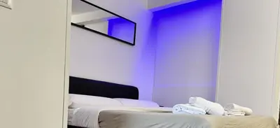 a bedroom with a mirror and a bed with white sheets at HOME Sweet Home Vatican City in Rome