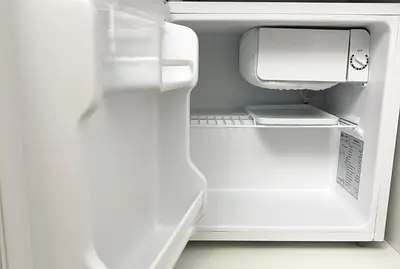an empty refrigerator with its door open with its door open at HOME Sweet Home Vatican City in Rome