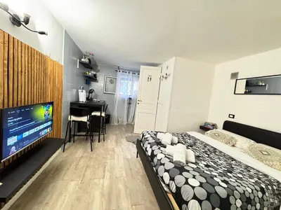 a bedroom with a bed and a flat screen tv at HOME Sweet Home Vatican City in Rome