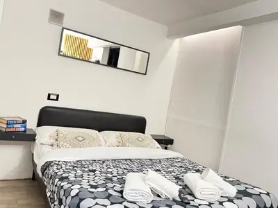 a bedroom with a bed with towels on it at HOME Sweet Home Vatican City in Rome