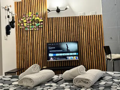 a room with a tv and a bed with towels at HOME Sweet Home Vatican City in Rome