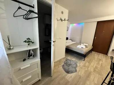 a room with a bedroom with a bed and a mirror at HOME Sweet Home Vatican City in Rome