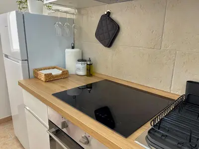 a kitchen with a counter and a refrigerator at LA DOLCE VITA - stone's throw from the city center in Rome