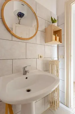 a bathroom with a white sink and a mirror at LA DOLCE VITA - stone's throw from the city center in Rome
