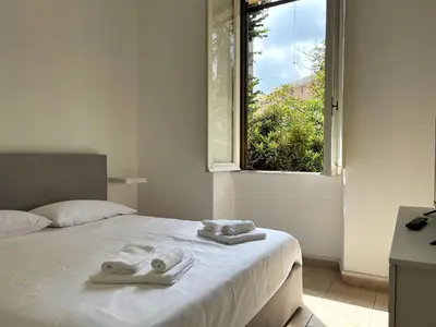 a bed with two towels on it with a window at LA DOLCE VITA - stone's throw from the city center in Rome