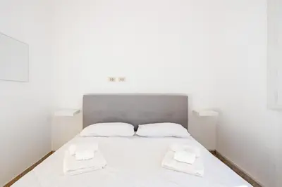 a white bed with two white towels on it at LA DOLCE VITA - stone's throw from the city center in Rome