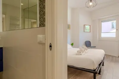 a small room with a bed and a mirror at Journalist Apartment Sistine Chapel in Rome