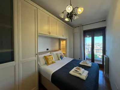 a bedroom with a bed with two towels on it at Nice View in Ostiense with balcony in Rome