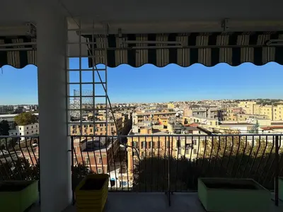 a view of a city from a large window at Nice View in Ostiense with balcony in Rome