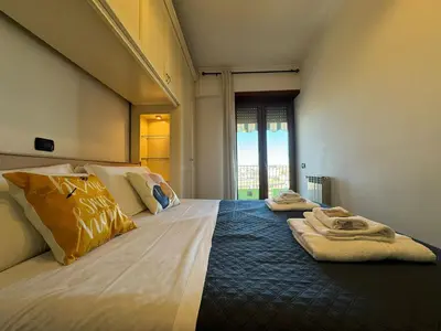 a bedroom with two beds with towels on them at Nice View in Ostiense with balcony in Rome