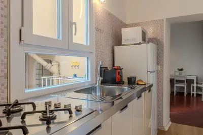 a kitchen with a sink and a refrigerator at Cozy Flat Orso Navona square in Rome