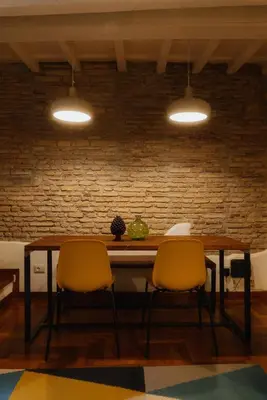 a dining room table with two chairs and two lights at Restart Accommodations Lante in Rome